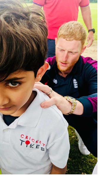 Ben Stokes signing a Cricket Tikes polo